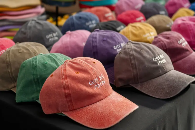 Baseball caps with embroidered lettering on a market stall