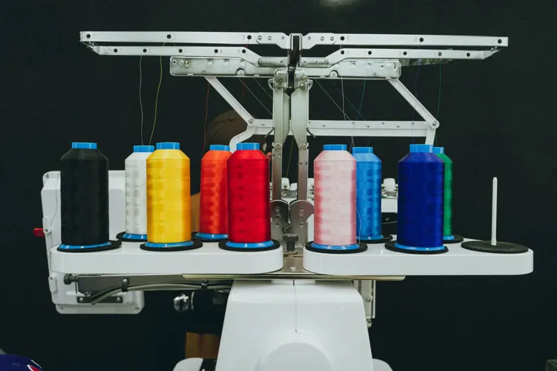Colorful thread cones loaded on an industrial embroidery machine