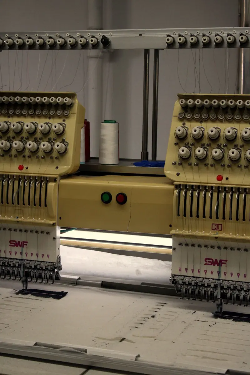 Multi-head commercial embroidery machines in a production shop