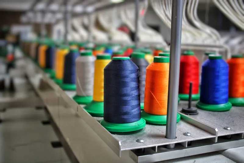 Rows of embroidery thread cones on a production line